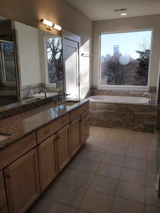 Master suite's bathroom - with a rejuvenating Jacuzzi tub boasting a view of Charlotte's skyline - 2039 Cartier Way