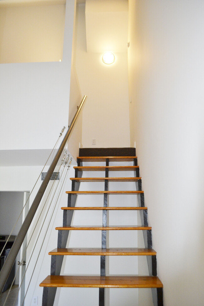 Front living room, stairs to loft. - 452 S Main St