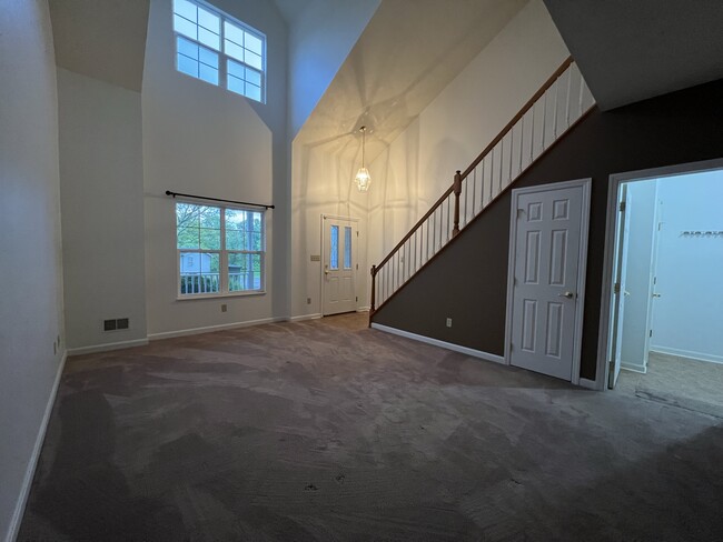 Floor to ceiling windows in living room give tons of natural light - 106 Trotter Ln