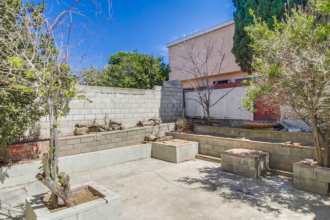 Here you go, this backyard is perfect for some sun & fun time w/ the family and dogs - 2304 E 14th St