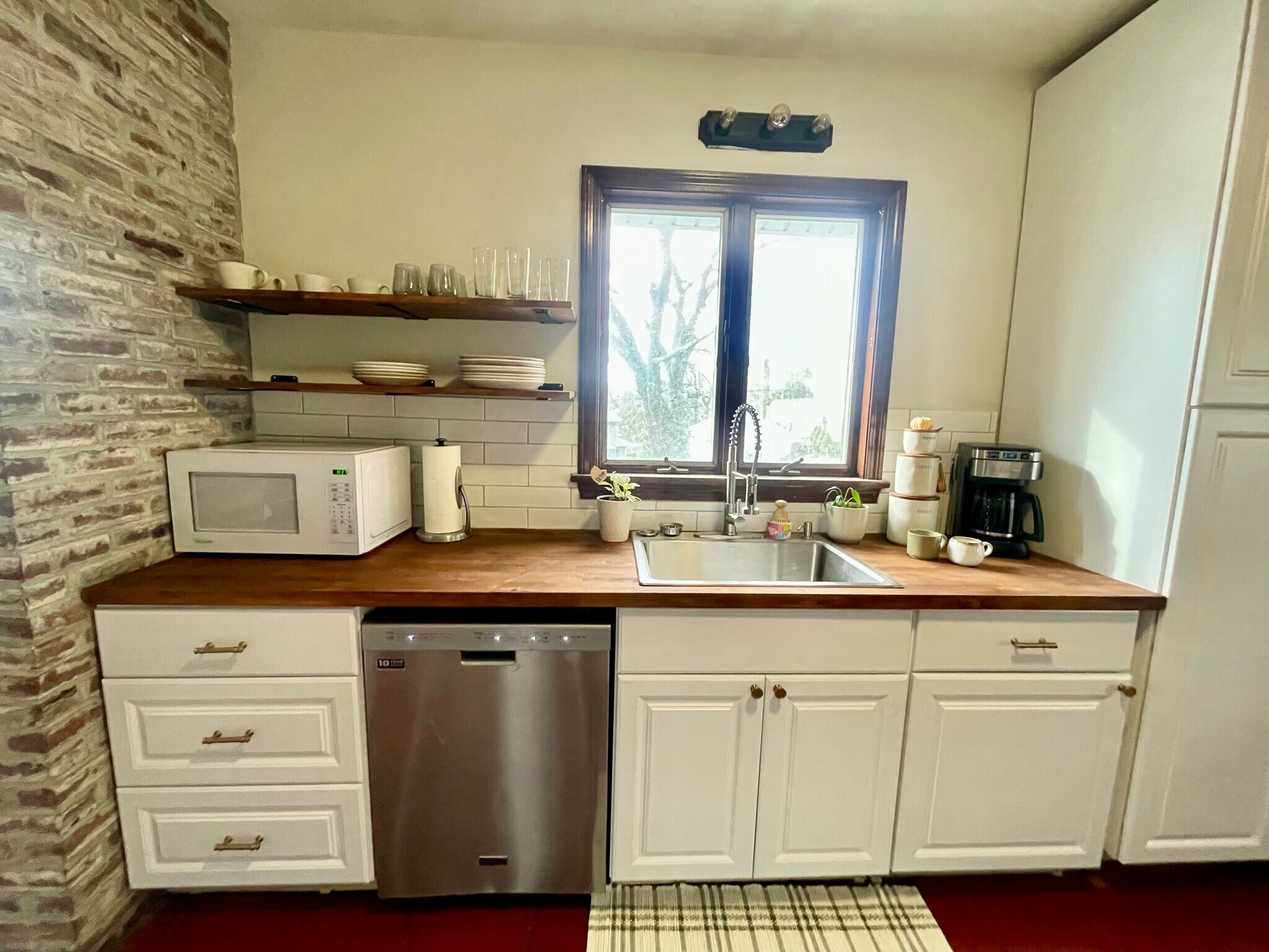 A brand new microwave has been added to the kitchen area along with open shelving. - 186 Linwood St