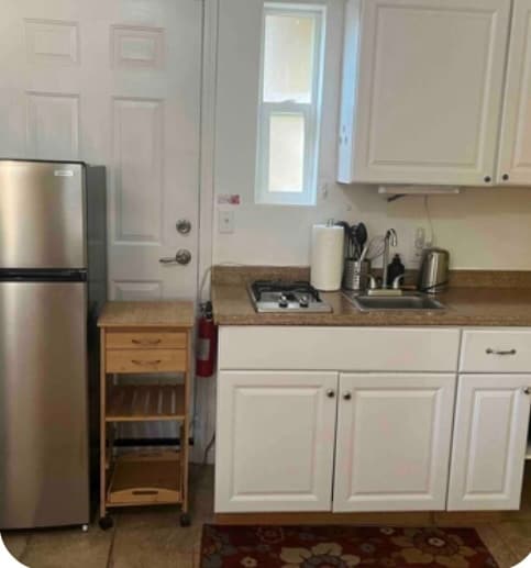 Fully equipped kitchenette with two burner stove and convenient appliances - 4000 McKinley Blvd