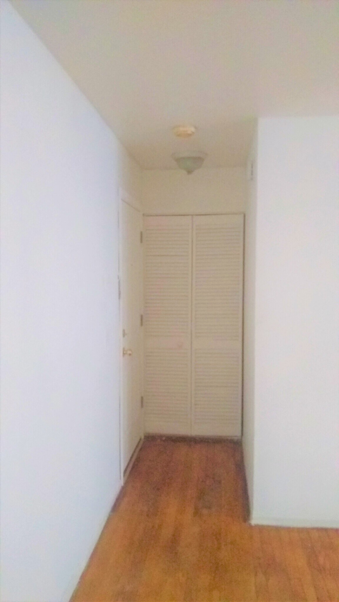 entrance of the apartment with small closet for coats and shoes - 5950 N Kenmore Ave