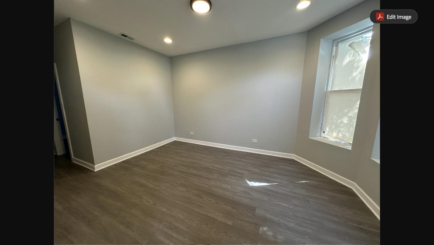 Spacious living room with large windows and brand-new luxury vinyl plank flooring - 5653 S May St
