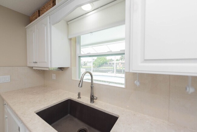 Building Photo - Live the ultimate Space Coast waterfront lifestyle at this stunning beachside canal home in Satel...