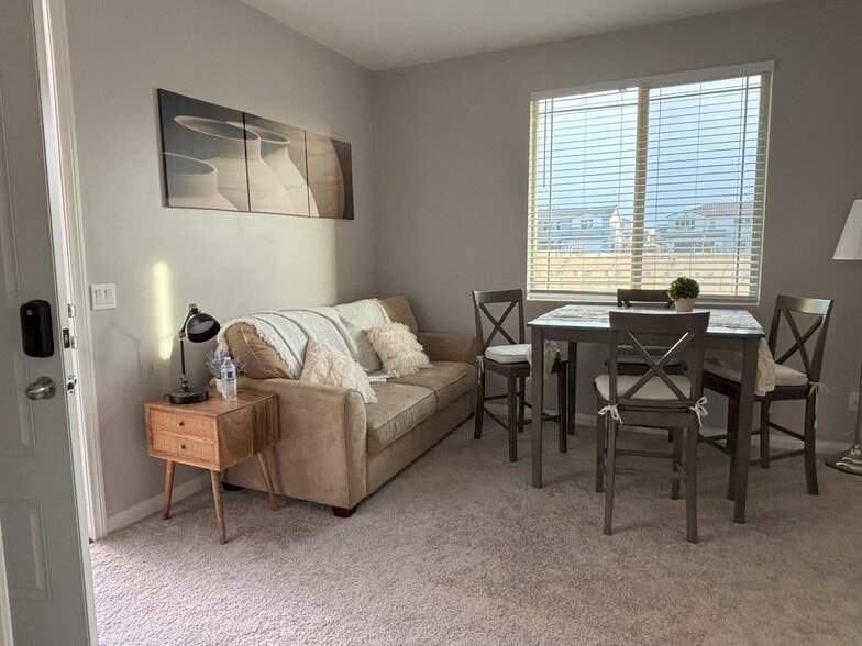 living room with plenty of natural light - 32914 Guinness Way