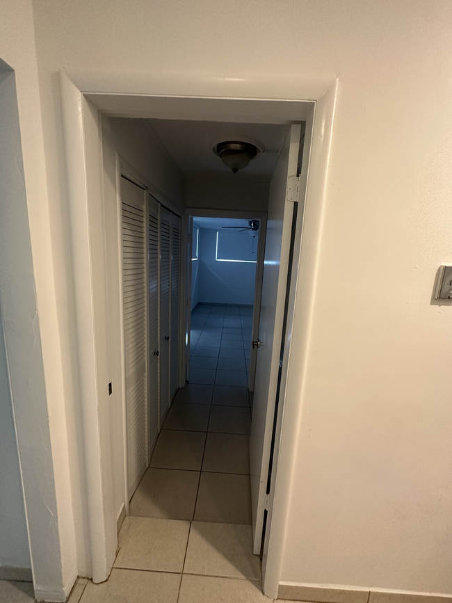 Hallway facing third guest bedroom and laundry room - 5400 Orduna Dr