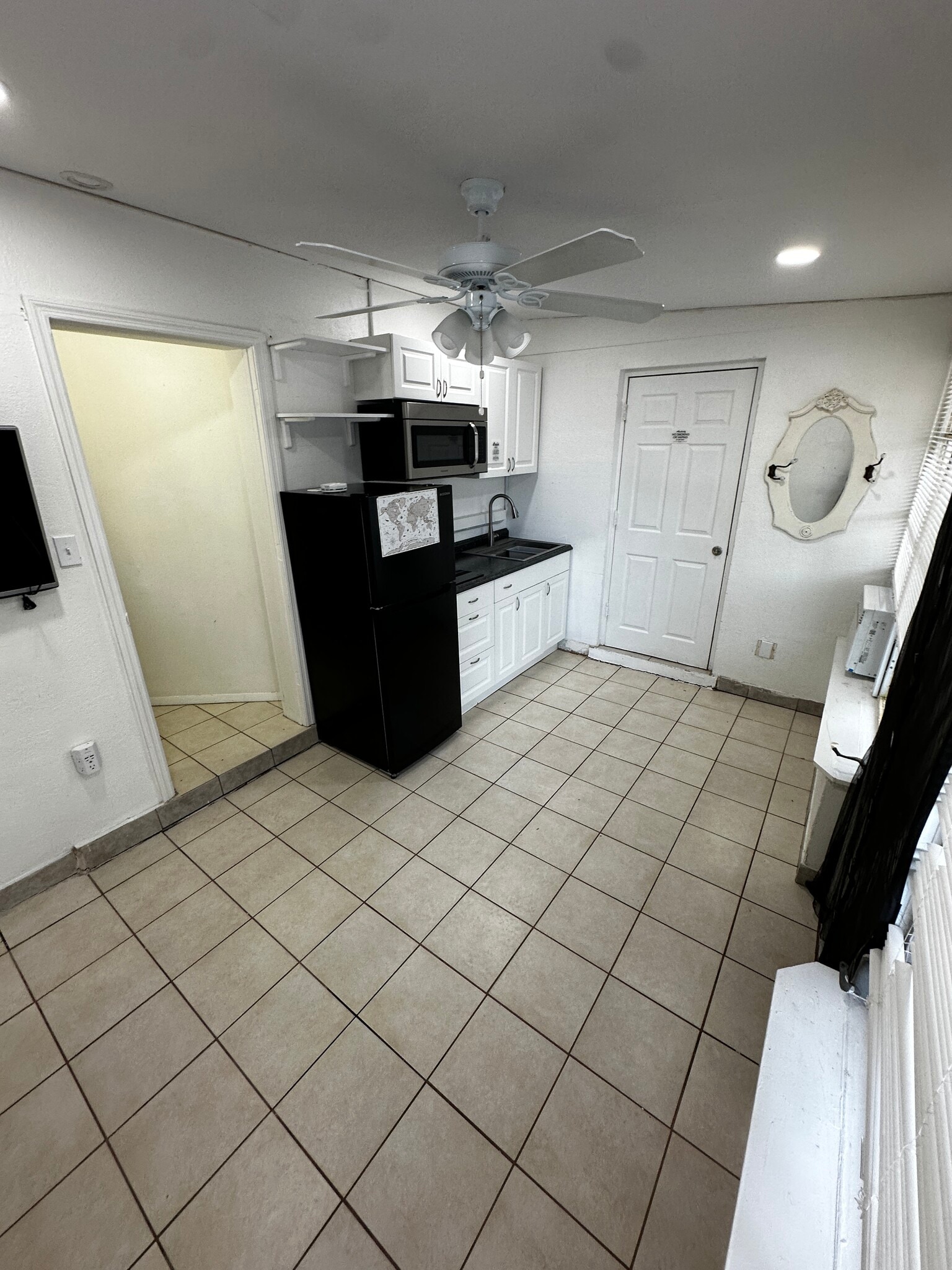 Kitchen area entrance pantry hallway and door to laundry room - 443 Granada Blvd