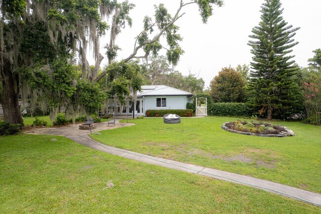 Building Photo - Lake Jessamine Luxury: Solar-Powered Waterfront Retreat on 1.14 Acres with Dock & Boathouse