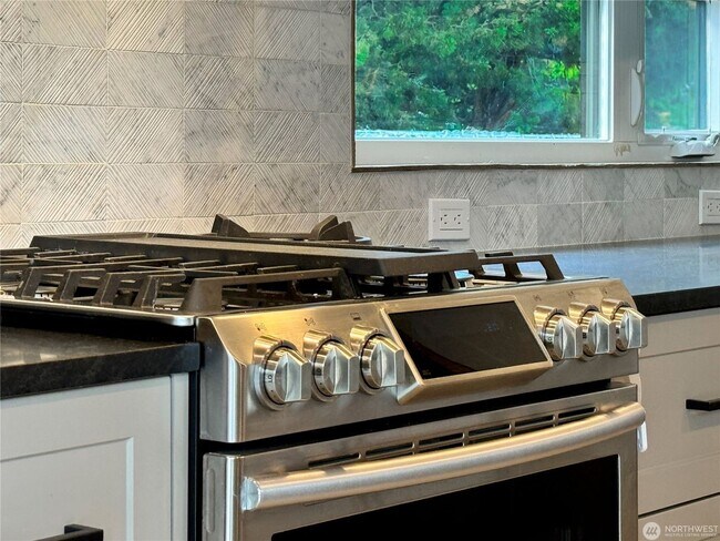Building Photo - Remodeled 3 bdrm home on a large lot with 500 sq ft wrap around deck!
