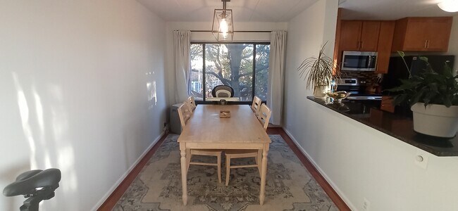Dining area can easily seat 12, with direct access to kitchen and living room. - 100 Roberts Ln