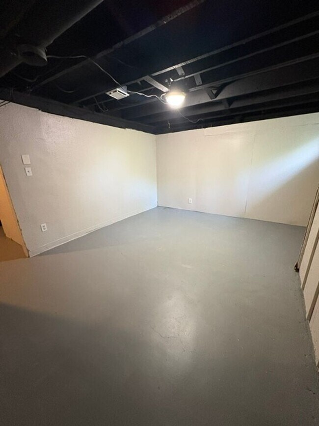 Building Photo - A cozy 2 bedroom home with versatile living space and plenty of storage including a partially fin...
