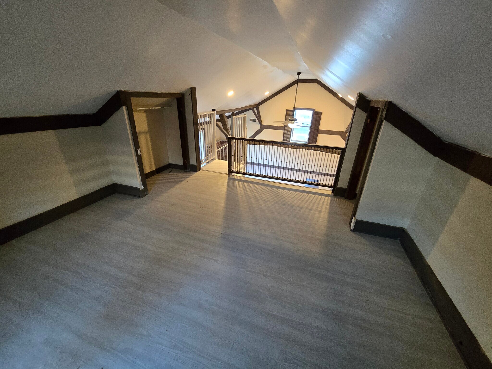 Loft area looking down to living area with exposed wood beams - 60 W Winter St