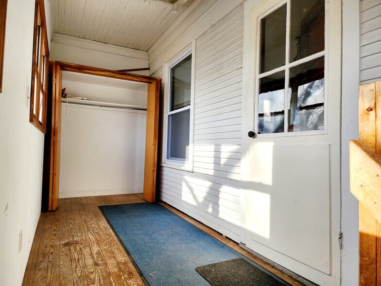 Back mudroom is bright and spacious, includes closet for additional storage - 3747 N Kostner Ave
