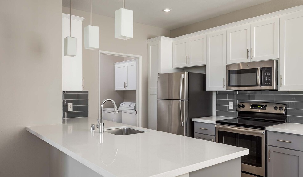 Kitchen features upgraded cabinets and quartz countertops - Saybrook Pointe