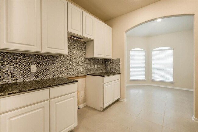 Building Photo - Beautiful stone front 4 bedroom, 3 bath home has bay windows in breakfast nook & master. It is on...