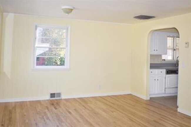 Building Photo - Updated house with original hardwoods and 2-car garage!