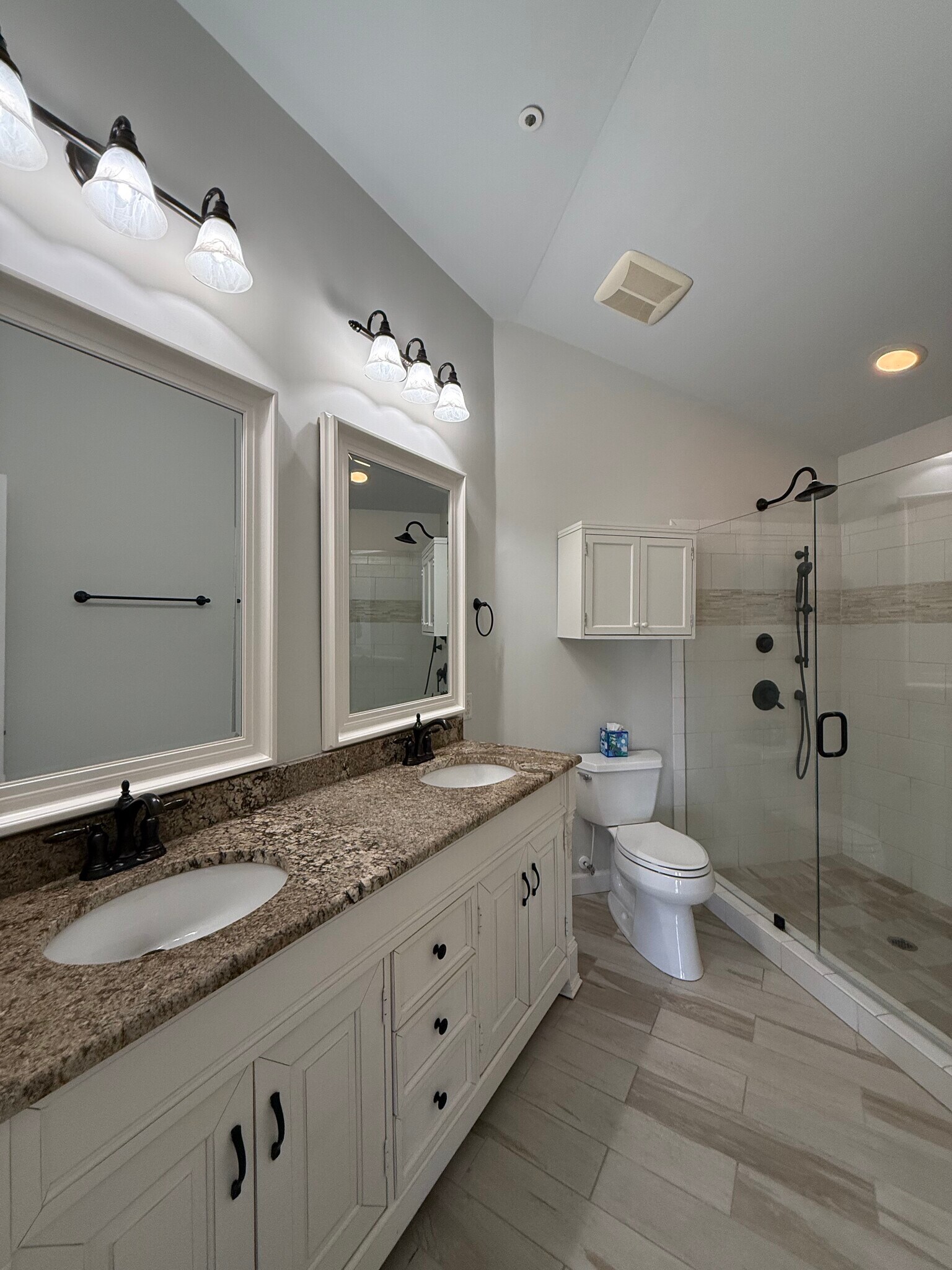 Primary bathroom with double vanity and tiled shower - 1133 Torrence Cir