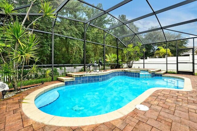 Building Photo - "Stunning 3BR Orlando Home with Private Screened Pool, Spa & Spacious Living Areas"