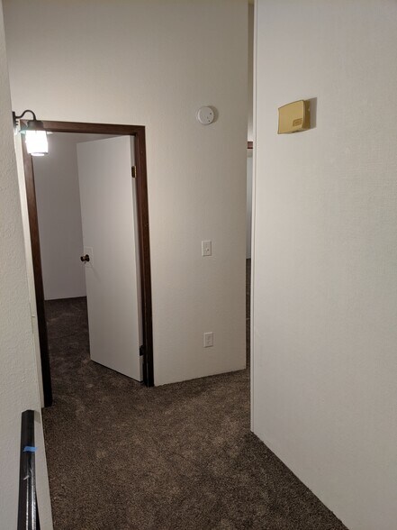 Landing at the top of the stairs looking towards bedroom 2. - 2115 Pleasanton St