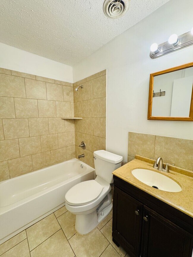 Building Photo - Cozy Meets Spacious: 4BR/2BA with Bonus Den & Patio