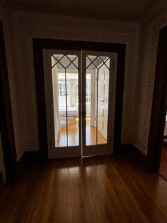 Closed glass doors (now with stretcher curtains) leading to sunroom bedroom. - 2615 Parker St