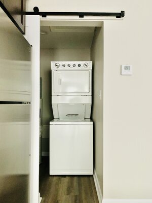Laundry room with additional shelving and barn door closure. - 1672 B. South Milledge Avenue