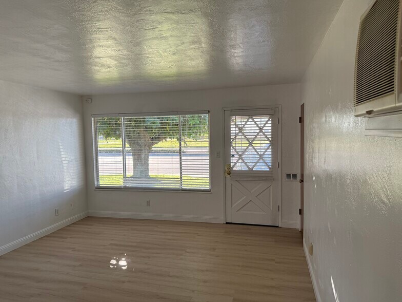 Living room with all new flooring. - 614 S Lower Sacramento Rd