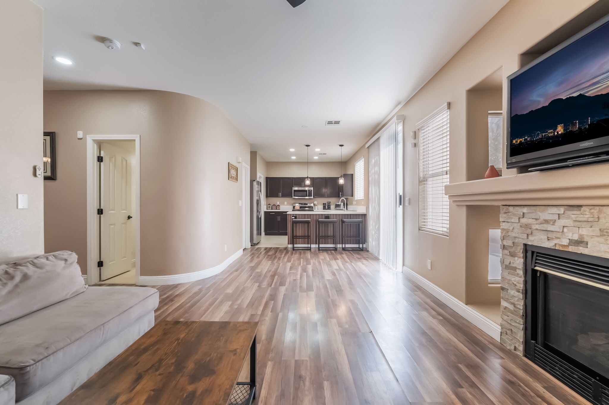 Unfurnished living room with a fireplace, light wood-style flooring, and recessed lighting - 1179 Antoinette St