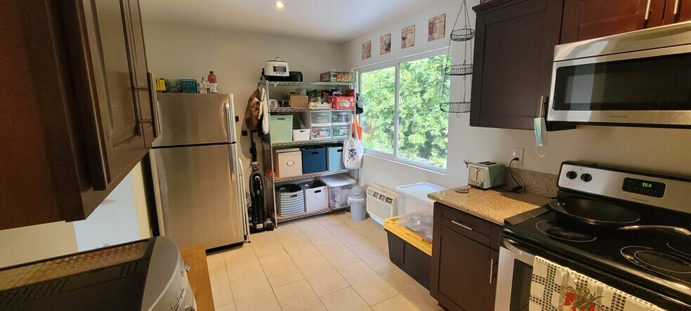 Kitchen, new refridge, oven w air fryer. Half the storage shelf is yours - 4281 Lowell St