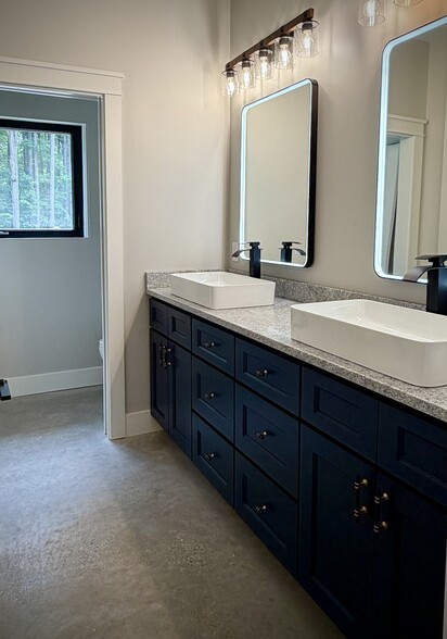 Leathered granite counters, LED mirrors, pocket door toilet area for privacy. - 10671 US 31