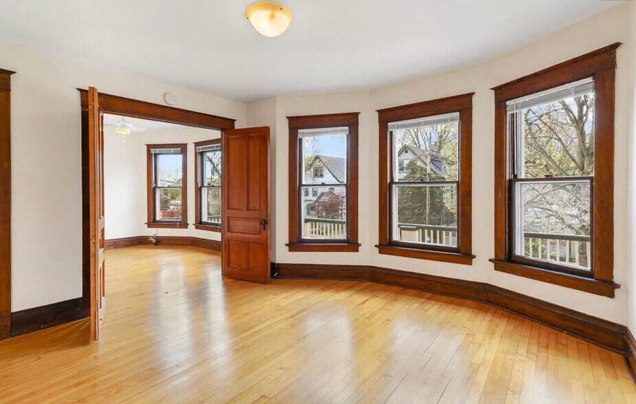 Living Room facing street. Double doors to Bedroom. - 707 S Dickinson St