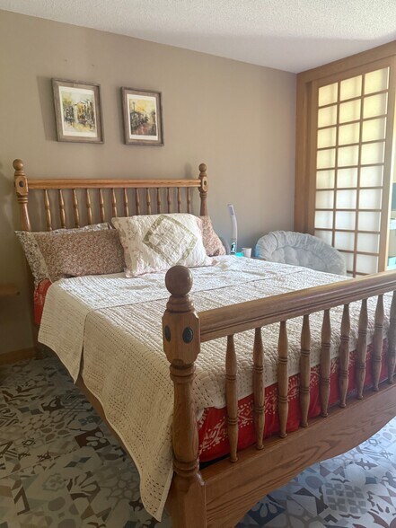 The master bedroom with a wood-burning fireplace - 4888 Tee Ct SW