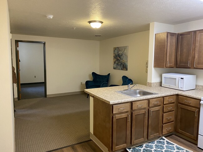 Kitchen with Wood Cabinets - Carson Square Apartments