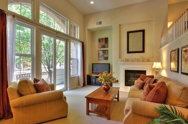 Building Photo - UPGRADED TOWNHOME IN RIVERMARK SOUGHT-AFTER WALK-UP SETTING