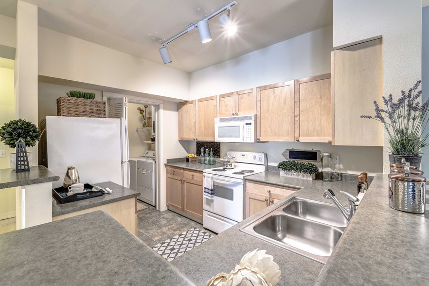 Open kitchens with energy efficient appliances, including dishwasher and mounted microwave - The Lodge at Redmond Ridge