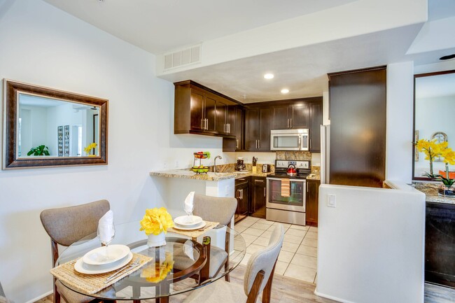 Kitchen and dining area at L'Estancia Apartment Homes - L'Estancia