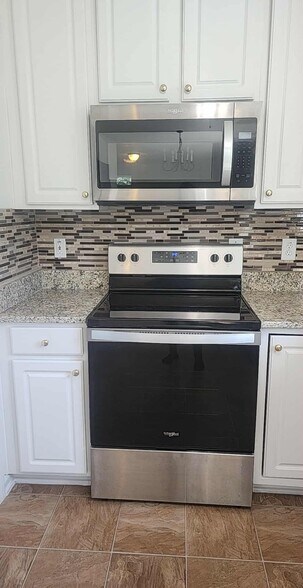 Whirlpool microwave and electric range. - 837 Shackleton Rd