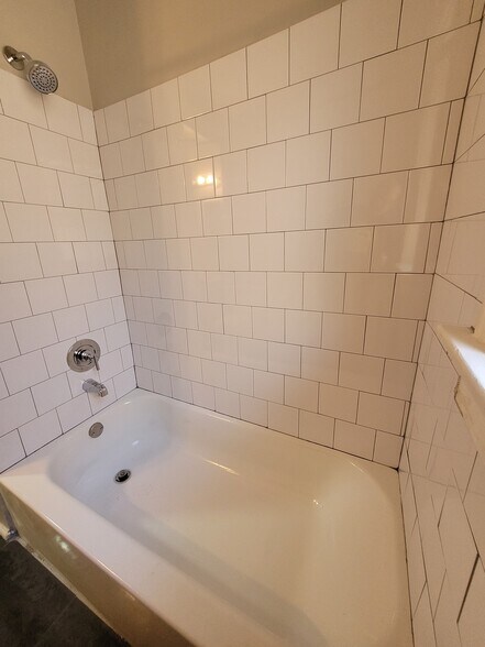 New bathtub and tile surround. - 2055 Alfred Ave
