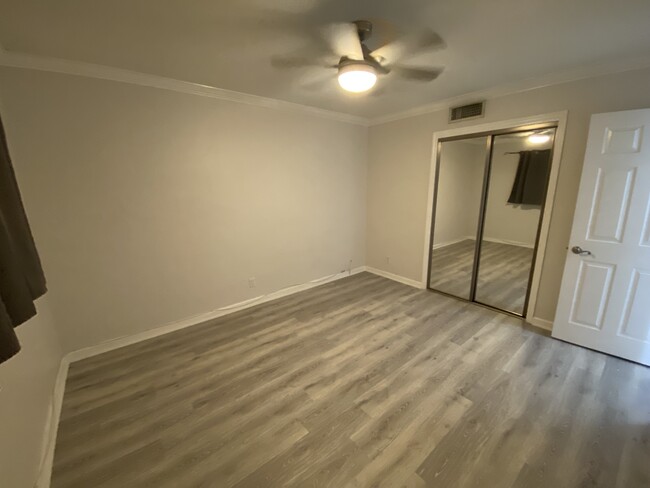 New soft grey LVP flooring in bedroom - 1012 SE 15th St