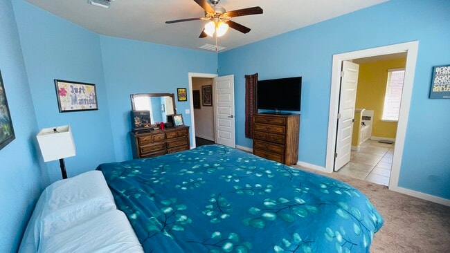 Master bedroom with ceiling fan - 7108 Garnet Mill Ln