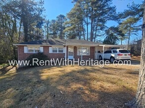 Building Photo - Great Brick Ranch / Harwood Floors / Huge Shop or Extra Storage / No Garage / Great Private Back ...