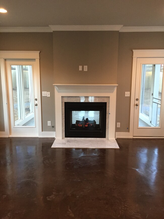 See through fireplace to screened in porch - 1003 Dew St