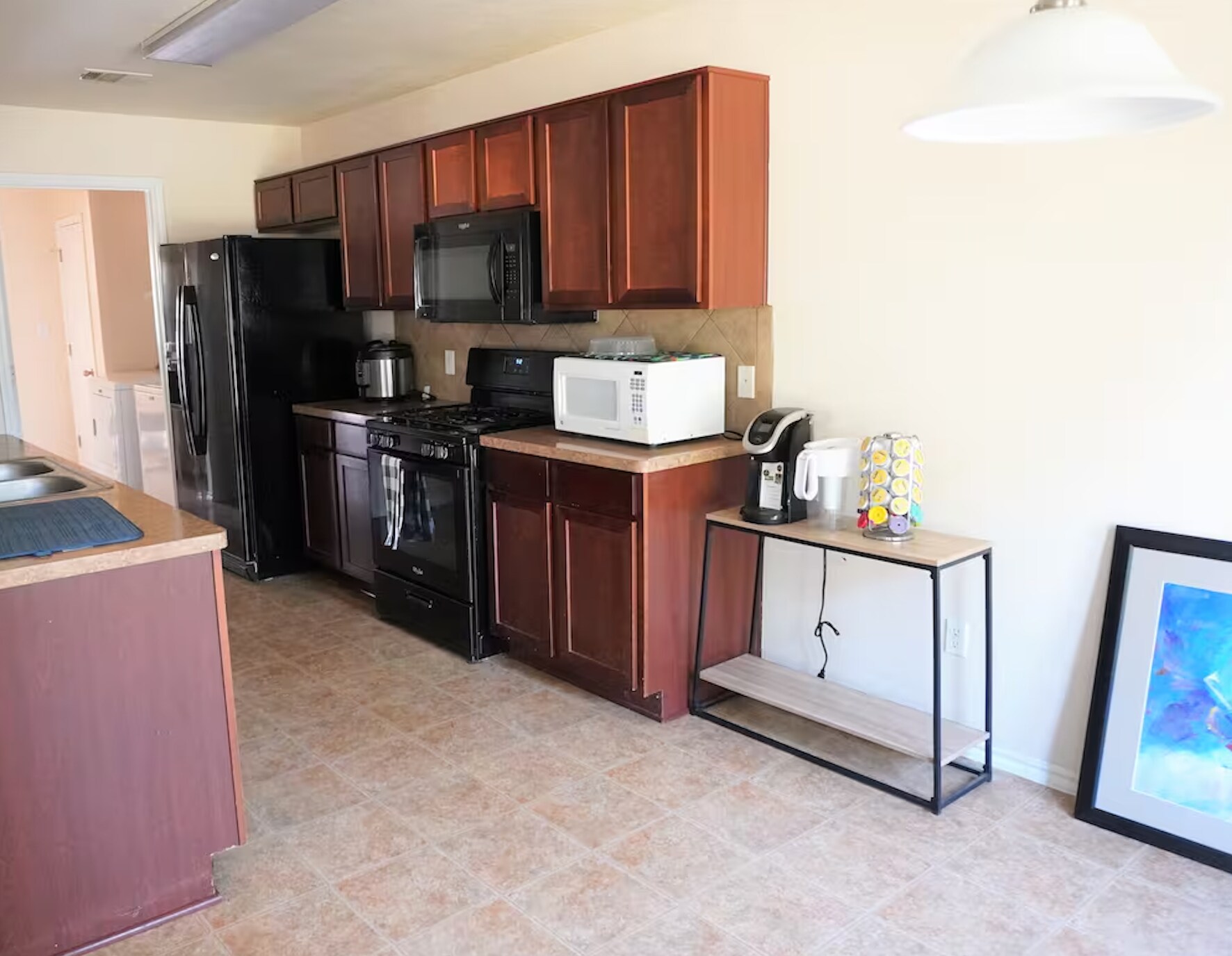Functional kitchen layout is equipped with Instant pot, microwave, and Keurig machine for your cooki - 15106 Parrish Ln