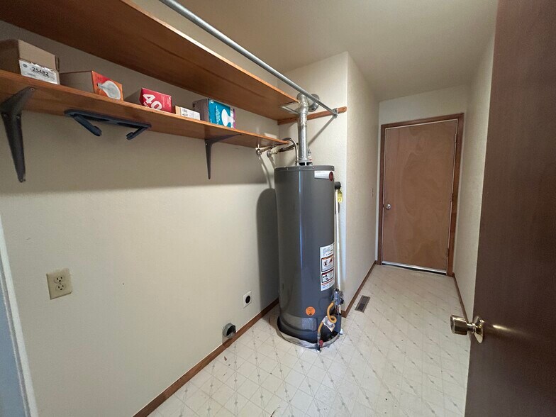 Laundry room has washer and dryer hookups. The door leads to a 2-car garage. - 4393 N Lincoln Ave