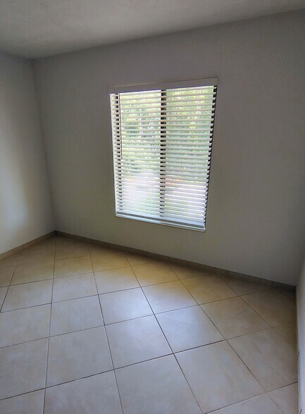 Main bedroom w/view of preserve; new ceiling fan - 1353 Pine Ridge Cir E