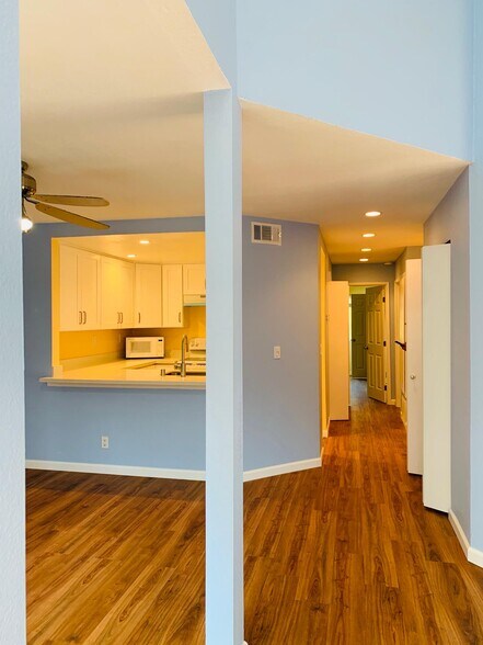 Kitchen and hallway with recessed lights and new LVP floor - 5318 Borneo Cir