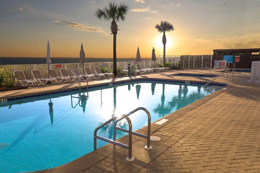 Relax by the pool as the sun sets over the Gulf - the perfect way to end your day in Panama City Bea - 10625 Front Beach Rd