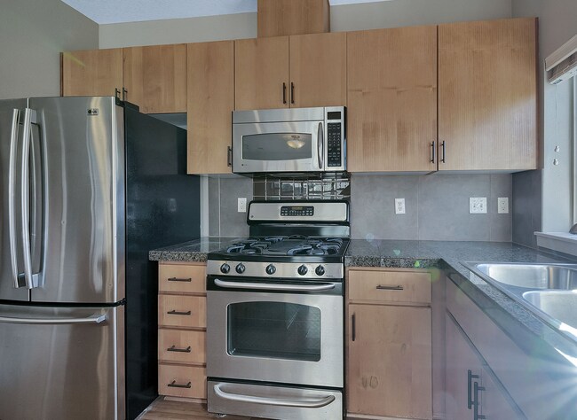 Building Photo - 2BR + 2.1BA Corner Townhome-Style Condo — Dual Primary Suites, Attached Garage & Most Utilities I...