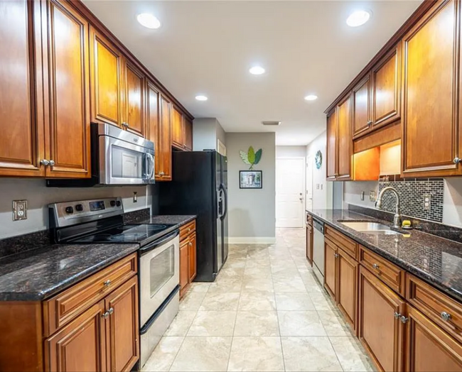 From the Kitchen Nook to the Kitchen looking West. Updated kitchen! Garage door at the end. - 12366 Copperwood Dr